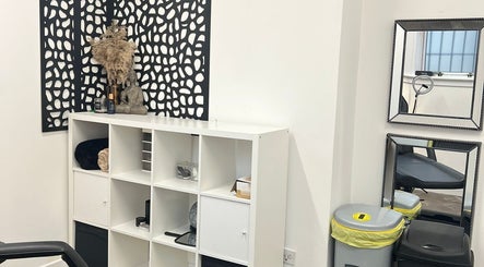 Cozy corner at Little Beauty Secrets, Cowdenbeath, Scotland, GB, featuring a shelf with decor and mirrors.