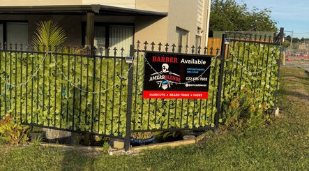 Barber shop sign at Amzadblendz in Auckland, NZ, highlighting services like haircuts and beard trims.