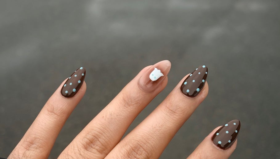 Brown nails with blue dots and an accent design at Nails by Gurleen, Delta, British Columbia, CA.