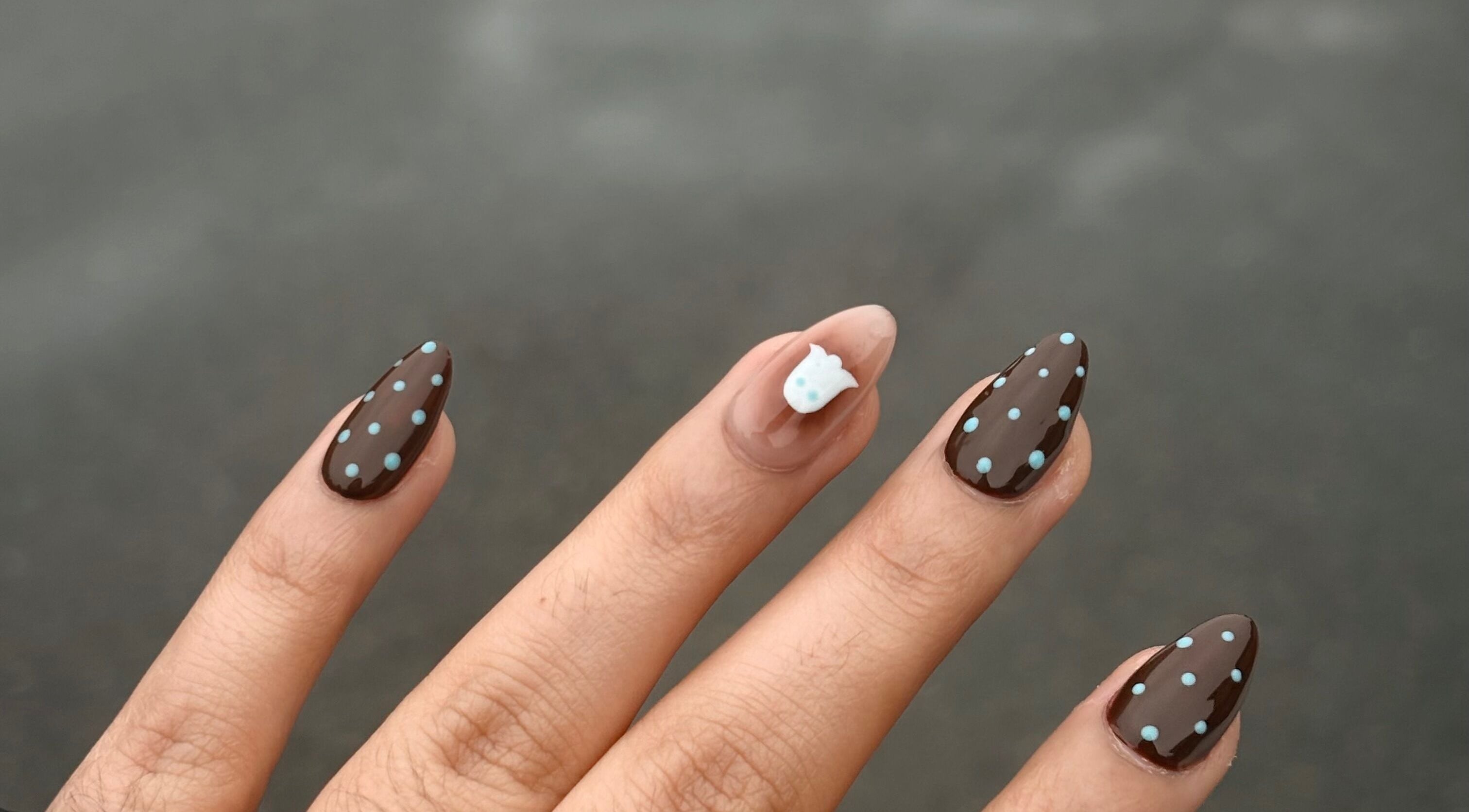 Brown nails with blue dots and an accent design at Nails by Gurleen, Delta, British Columbia, CA.