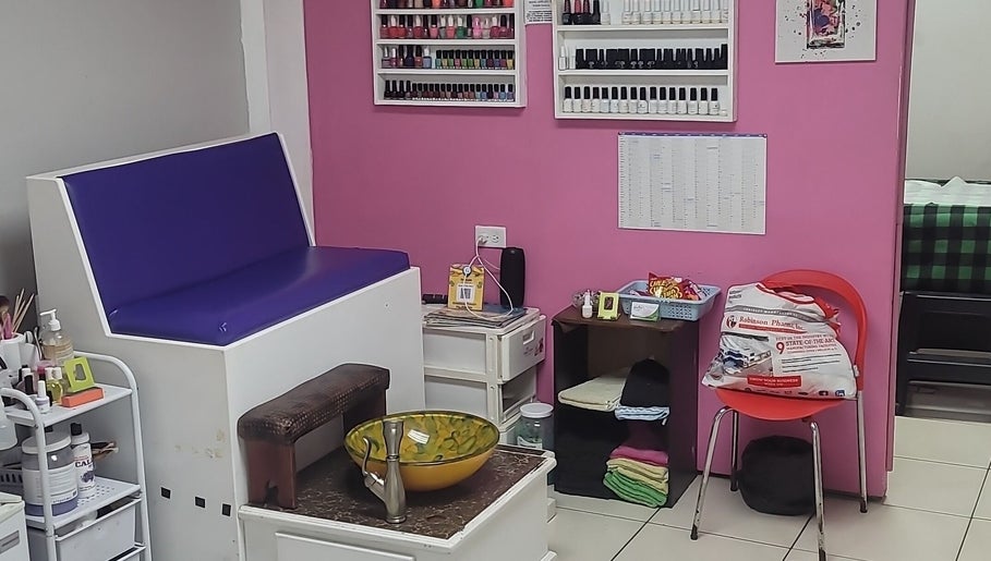 Interior of Gracious Touch by Joanna in Arima, featuring seating and nail polish display.