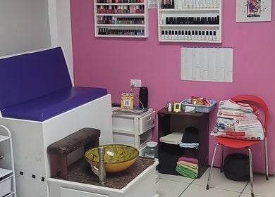 Interior of Gracious Touch by Joanna in Arima, featuring seating and nail polish display.