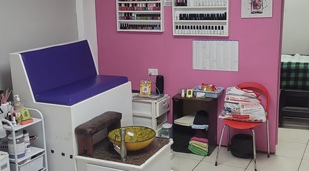 Interior of Gracious Touch by Joanna in Arima, featuring seating and nail polish display.