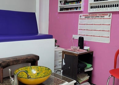 Cozy nail spa at Gracious touch by joanna, Arima, TT, featuring bold pink walls and colorful decor.