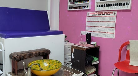 Cozy nail spa at Gracious touch by joanna, Arima, TT, featuring bold pink walls and colorful decor.