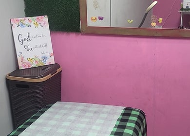 Cozy corner at Gracious Touch by Joanna, Arima with pink walls and decorative accents.