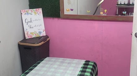 Cozy corner at Gracious Touch by Joanna, Arima with pink walls and decorative accents.