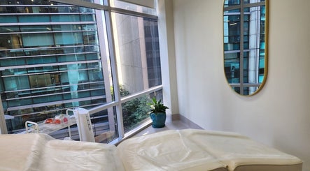 Relaxing treatment room at Glow Body & Mind, North Sydney, New South Wales, AU, with a city view.