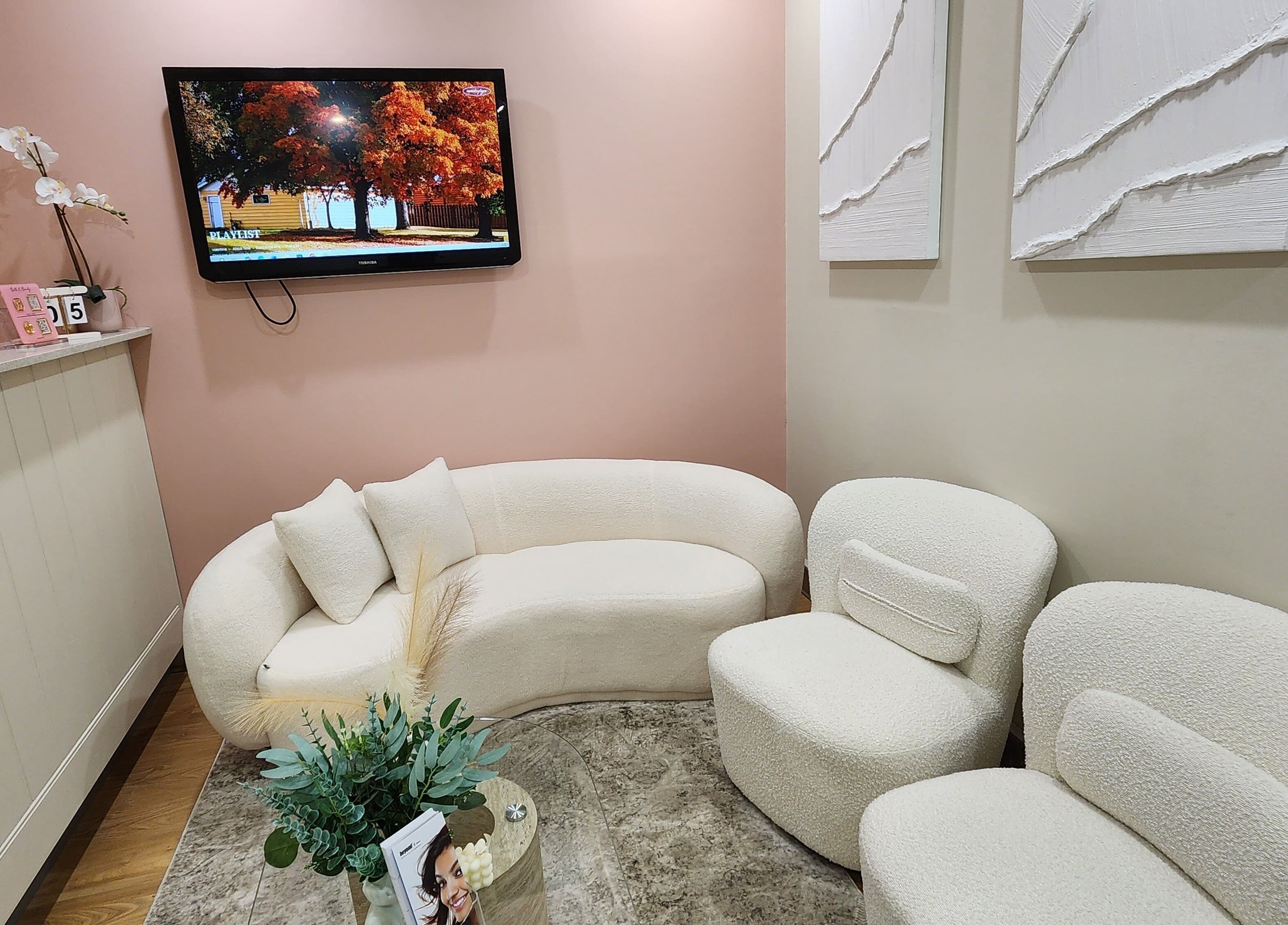 Inviting seating in Glow Body & Mind's North Sydney reception, featuring plush chairs and warm decor.