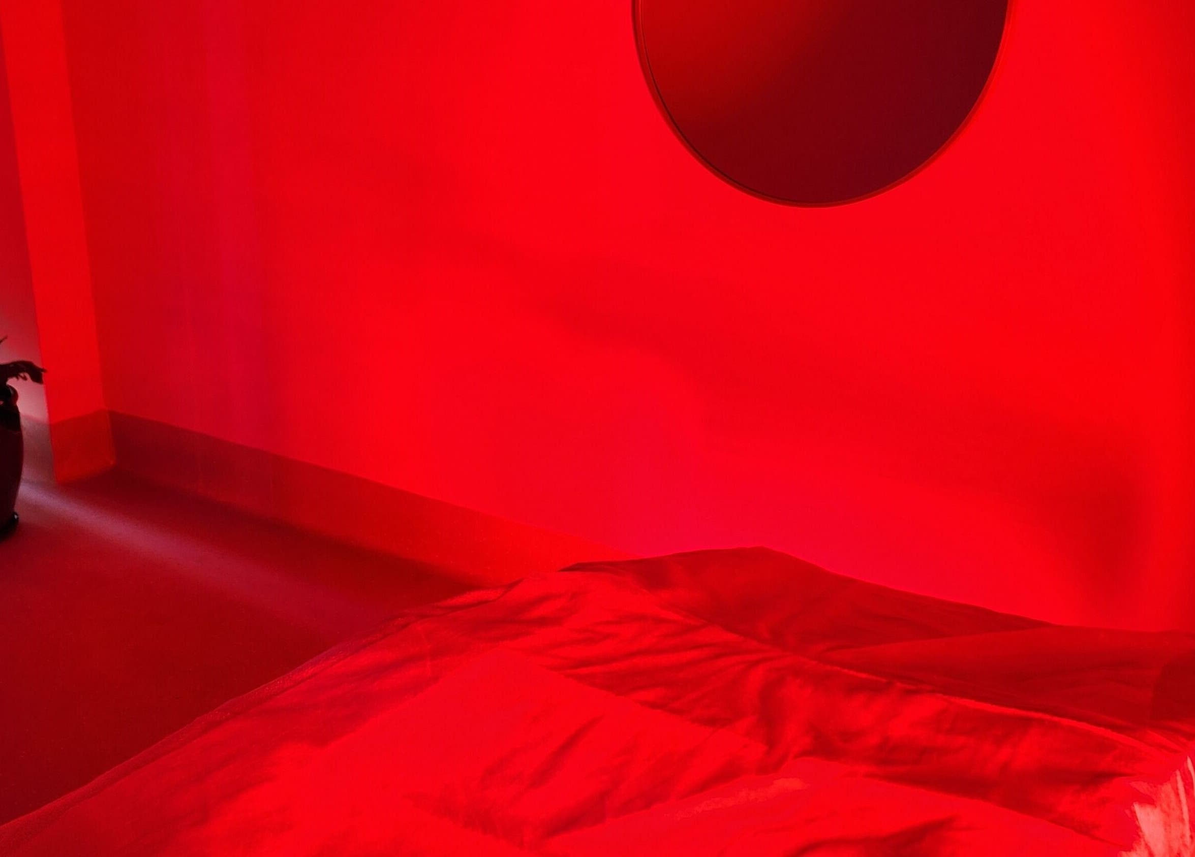 Relaxing therapy room with red ambiance at Glow Body & Mind, North Sydney, New South Wales, AU.