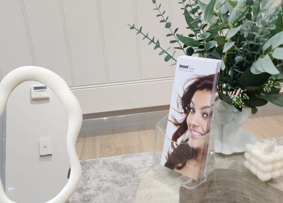 Elegant decor at Glow Body & Mind, North Sydney, featuring a unique mirror and lush greenery for a soothing ambiance.