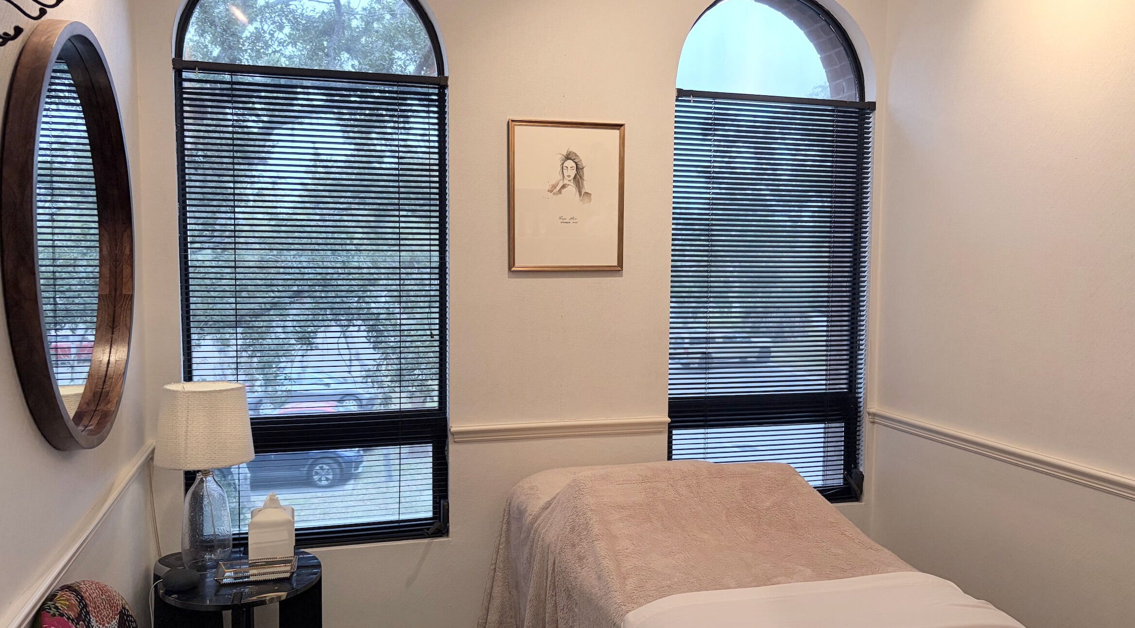 Cozy treatment room at SKIN ESTHETIC SRQ in Sarasota, Florida, US. Elegant decor with soft lighting and blinds.