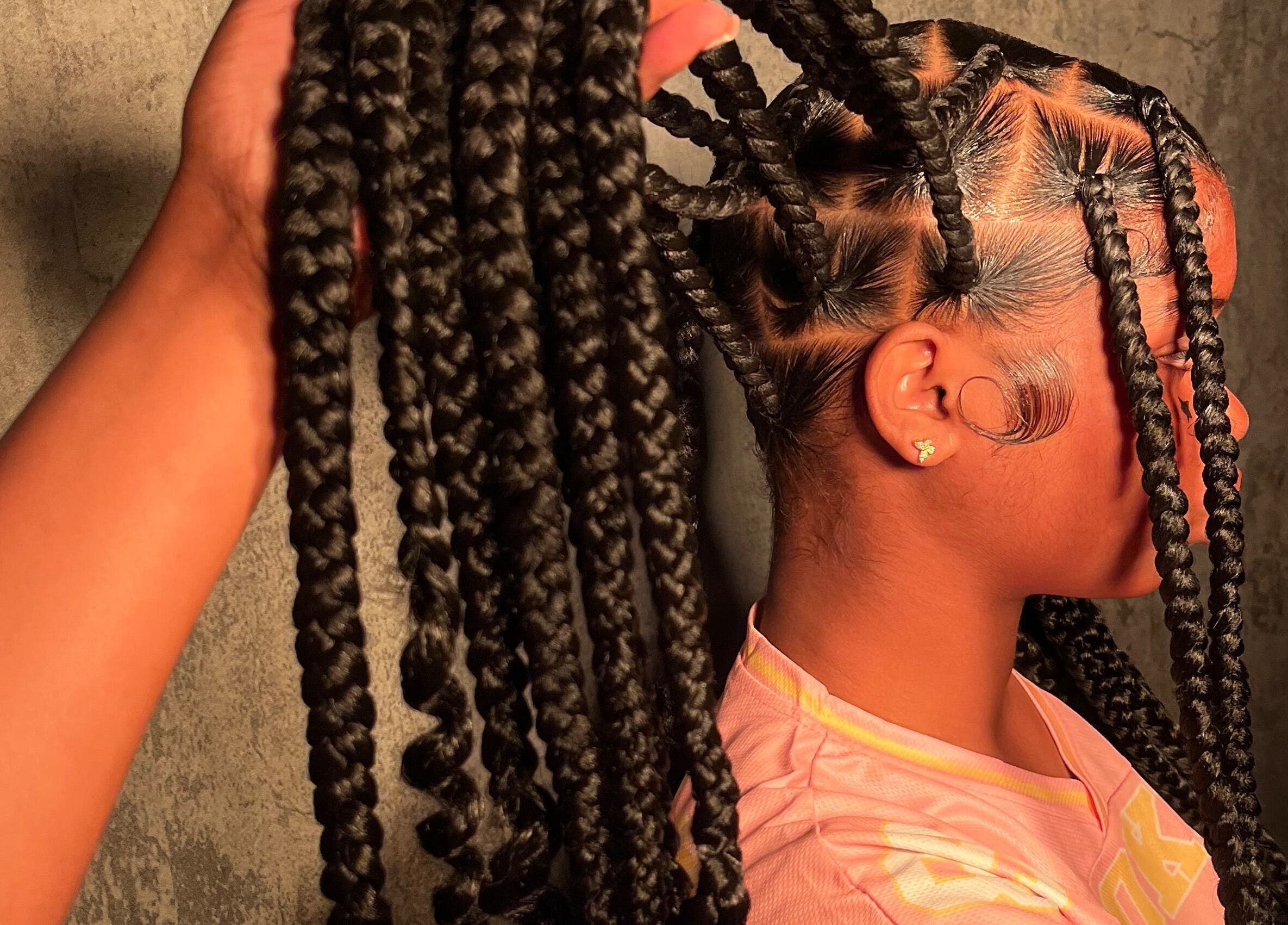 Elegant braided hairstyle at Touchedbymelly, Arima, Arima Borough Corporation, TT. Experience expert styling.