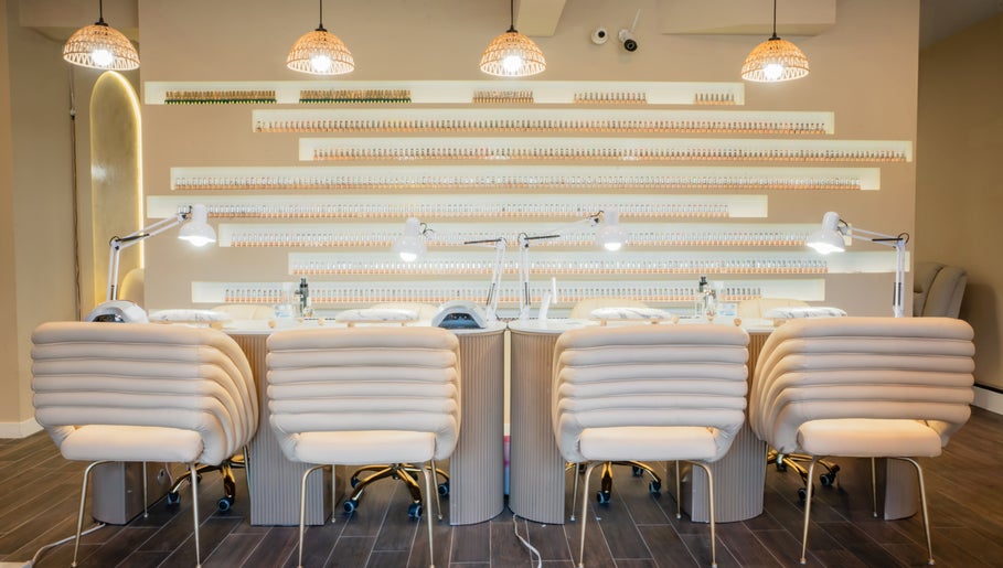 Chic nail salon interior at Mèye, Montréal, Québec, CA showcasing elegant chairs and modern lighting.