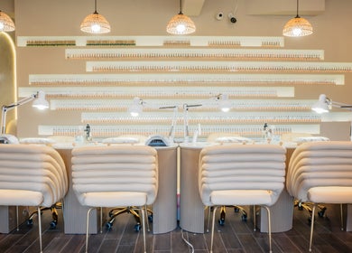 Chic nail salon interior at Mèye, Montréal, Québec, CA showcasing elegant chairs and modern lighting.
