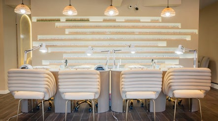 Chic nail salon interior at Mèye, Montréal, Québec, CA showcasing elegant chairs and modern lighting.