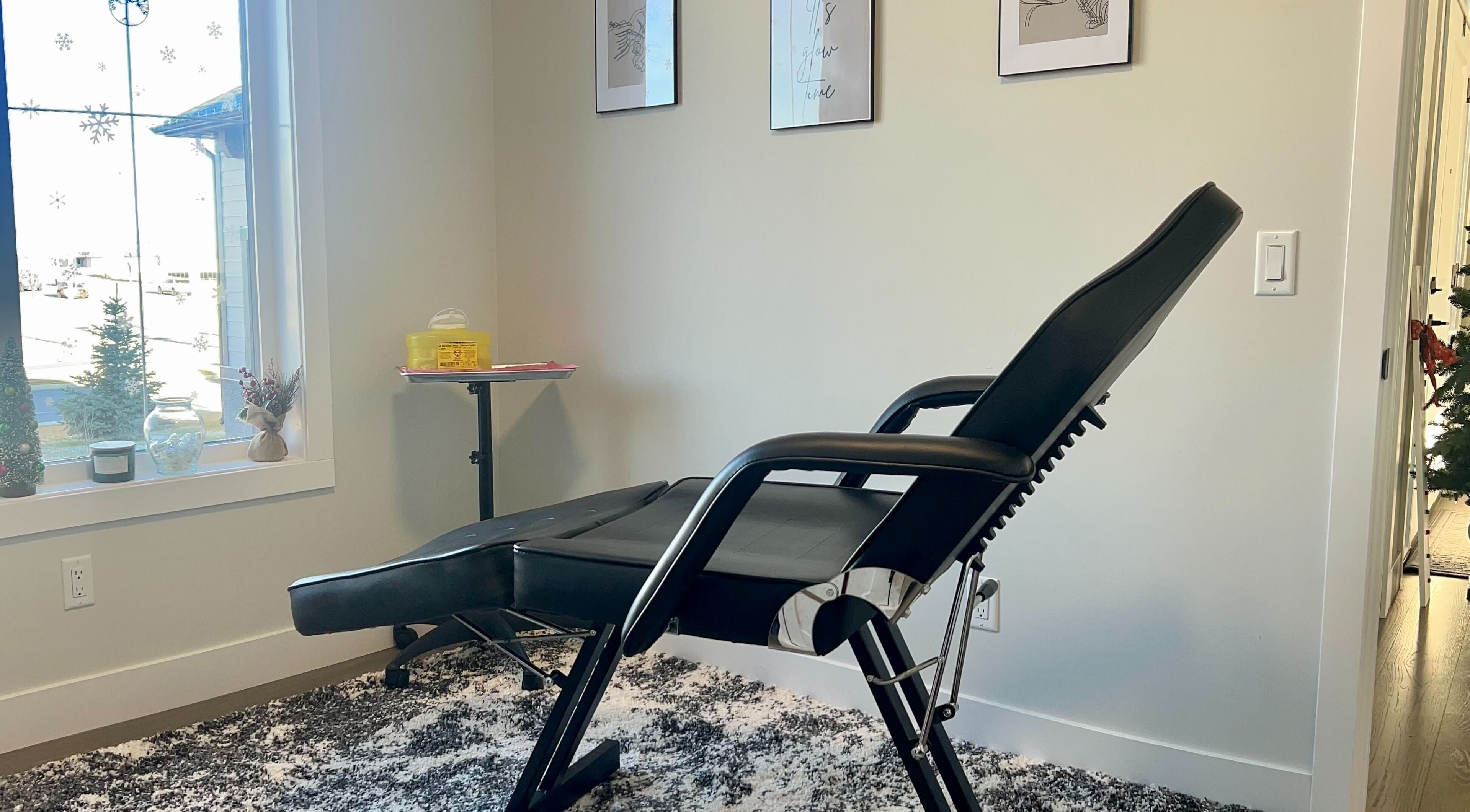 Relaxing treatment room at Botox Beautiful, Okotoks, Alberta, CA with cozy chair and serene decor.