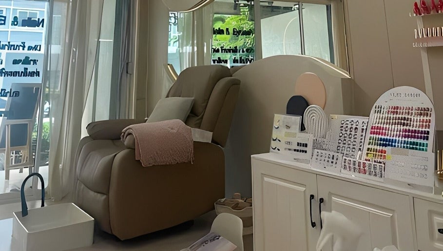 A cozy pedicure chair at Diva Nailslash, Krung Thep Maha Nakhon, with nail color samples displayed.