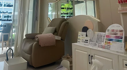 A cozy pedicure chair at Diva Nailslash, Krung Thep Maha Nakhon, with nail color samples displayed.