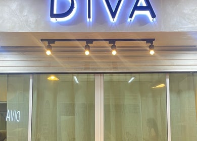 Entrance sign of Diva Nailslash in Krung Thep Maha Nakhon, featuring illuminated lettering.
