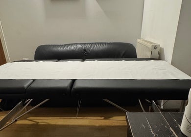 Massage table in X-X, a serene venue in London, England, GB, ready for relaxation and therapy.