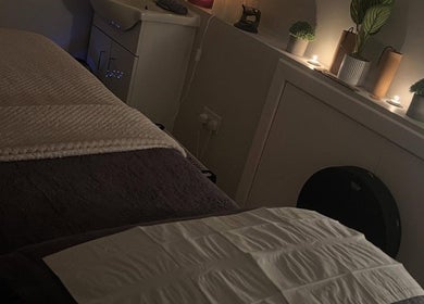 Cozy room setup at Manifest Hypnotherapy in Kirkintilloch, Scotland, GB, featuring soft lighting and a treatment table.