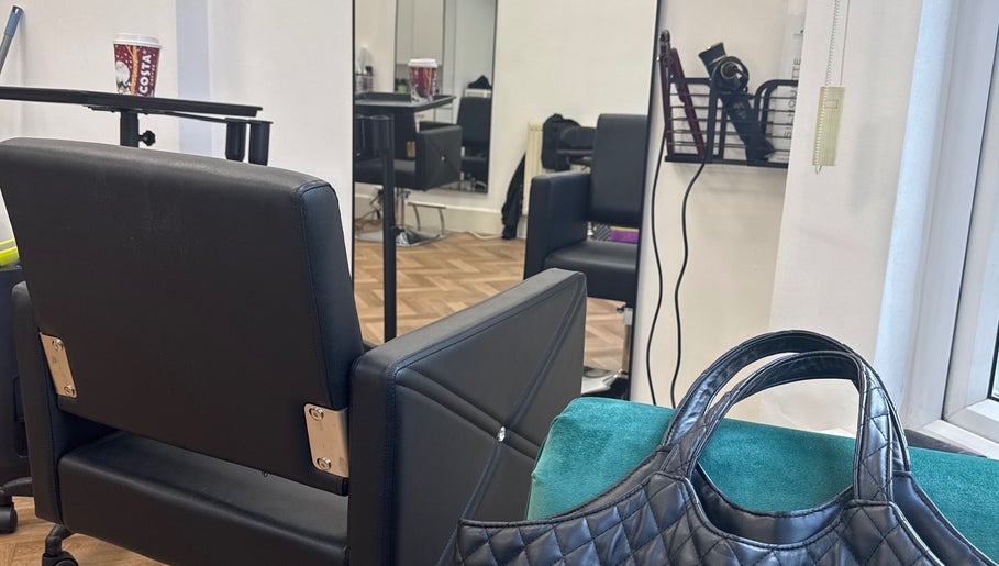 Chic interior of Maria Salon in London, England, GB, featuring a stylish chair and mirror setup.