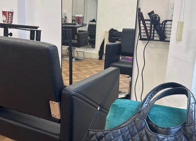 Chic interior of Maria Salon in London, England, GB, featuring a stylish chair and mirror setup.