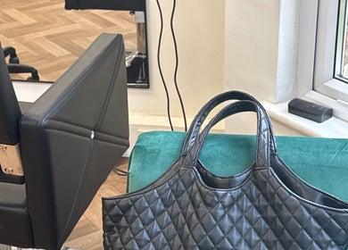 Stylish salon chair and bag at Maria Salon, London, England, GB. Experience luxury and comfort.