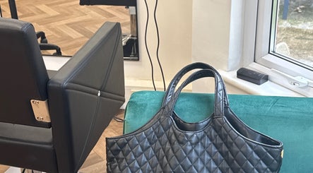 Stylish salon chair and bag at Maria Salon, London, England, GB. Experience luxury and comfort.