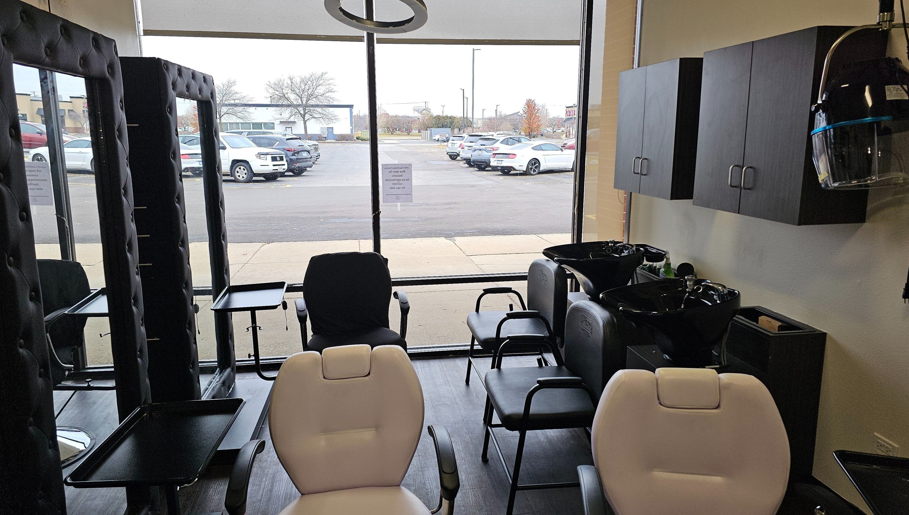 Chic interior of MICKnifEcYnt Artistry in Oswego, Illinois, with salon chairs and hair wash stations.