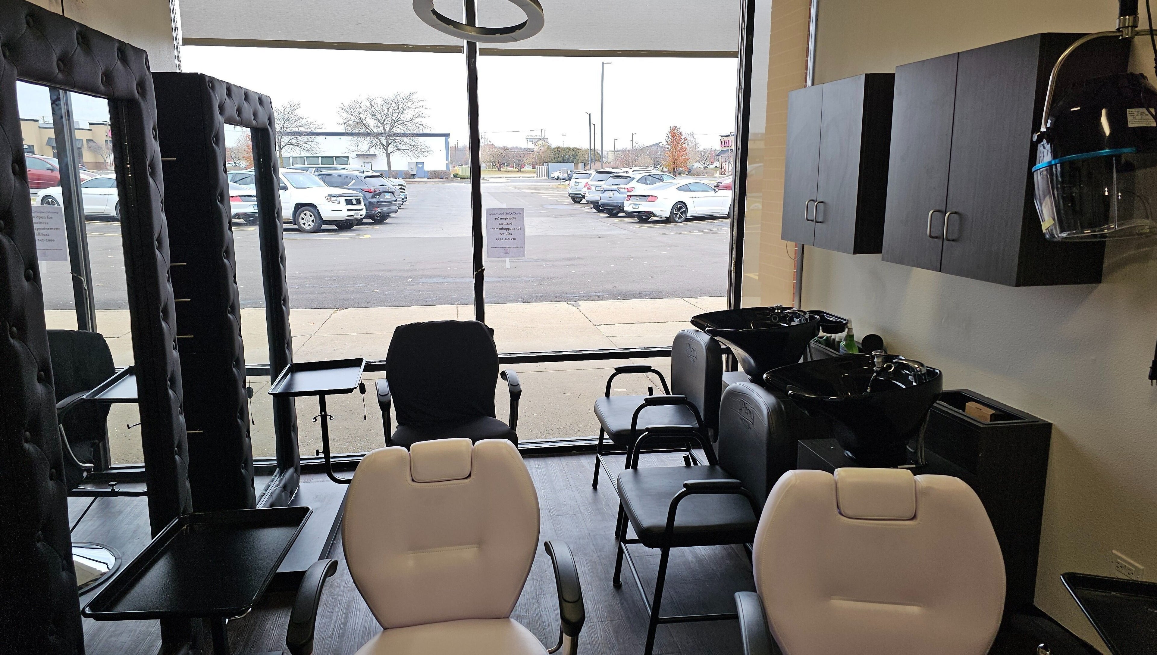 Chic interior of MICKnifEcYnt Artistry in Oswego, Illinois, with salon chairs and hair wash stations.