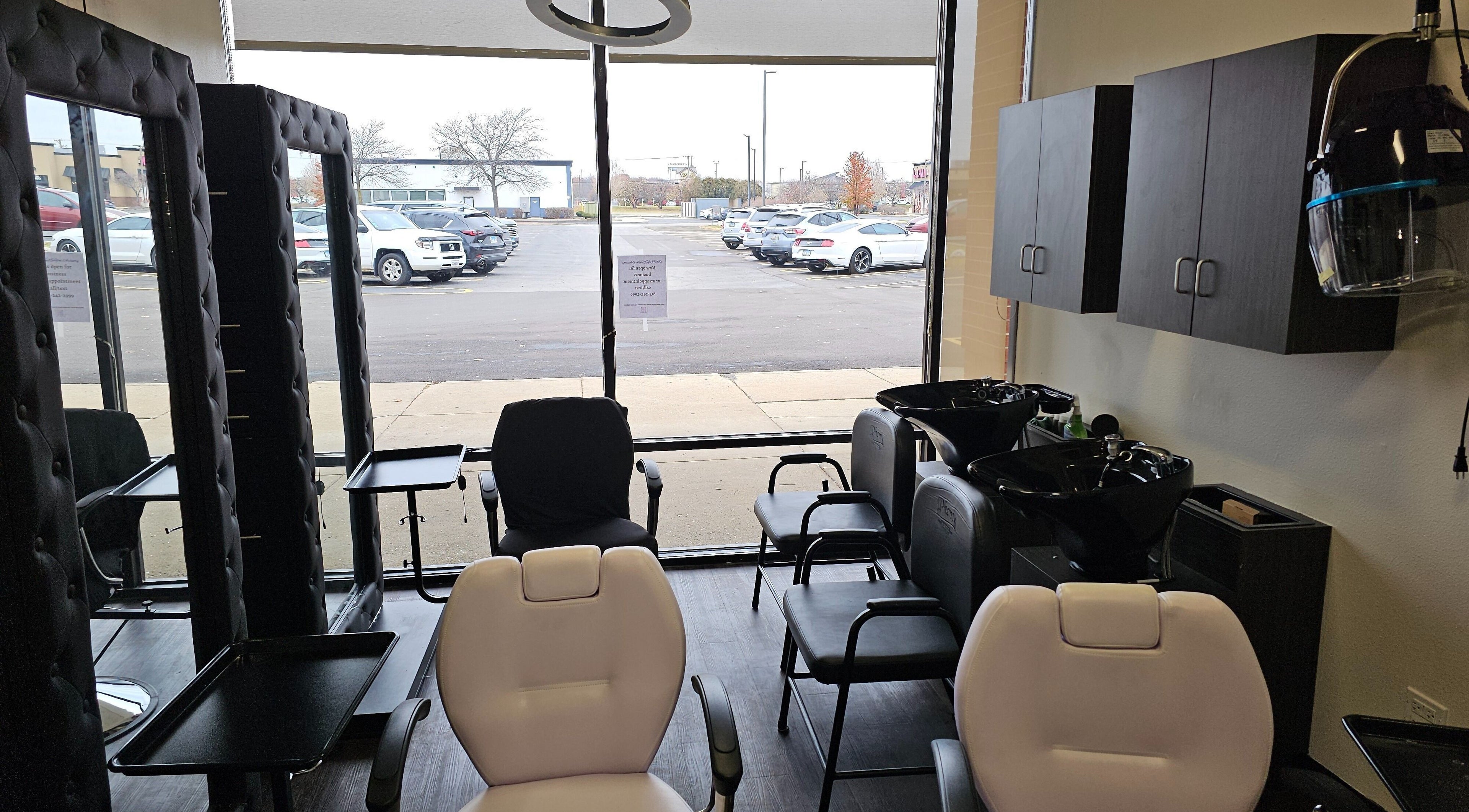 Chic interior of MICKnifEcYnt Artistry in Oswego, Illinois, with salon chairs and hair wash stations.