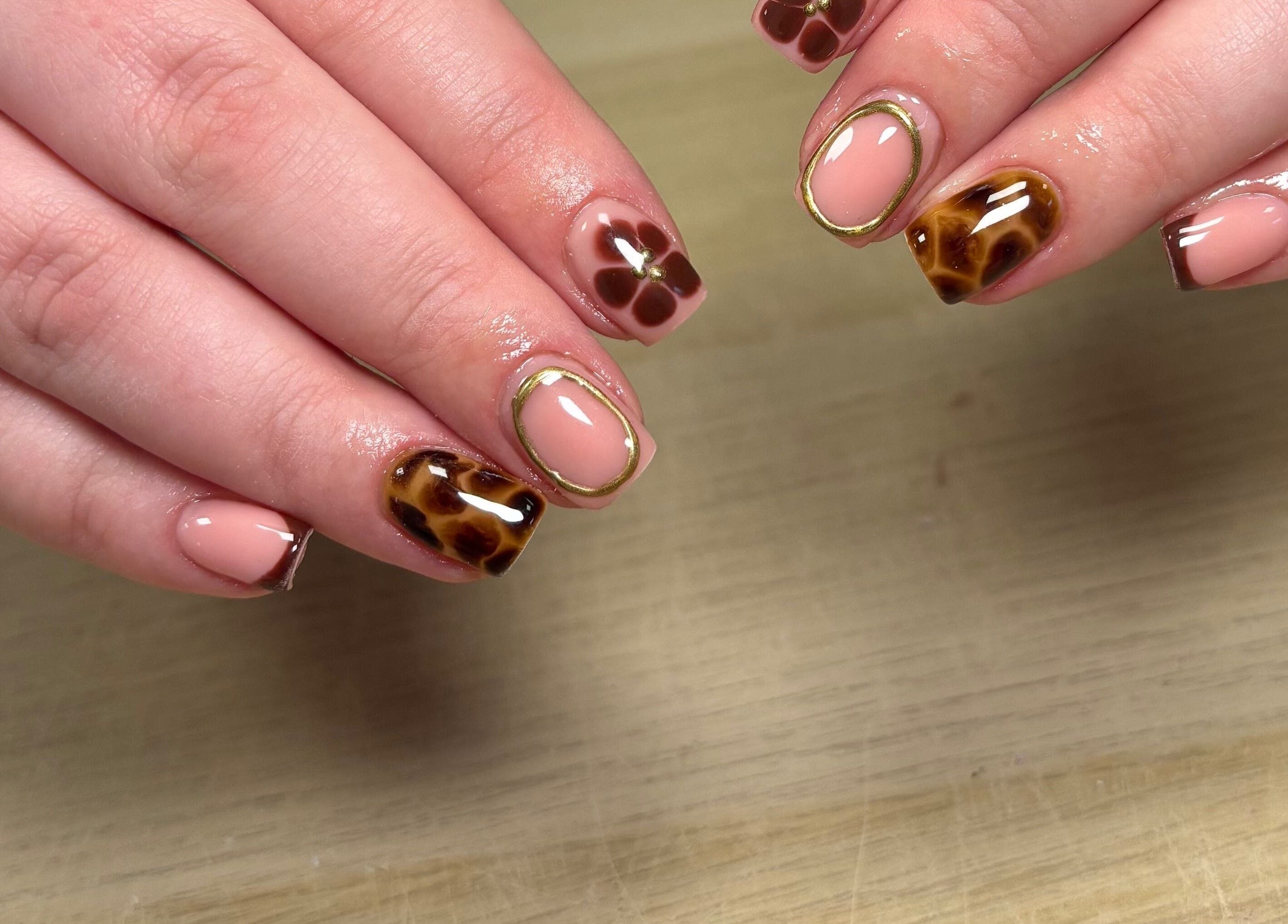 Elegant nail art design at Ibrowednlashed, Glasgow, Scotland, GB, featuring neutral tones and intricate patterns.