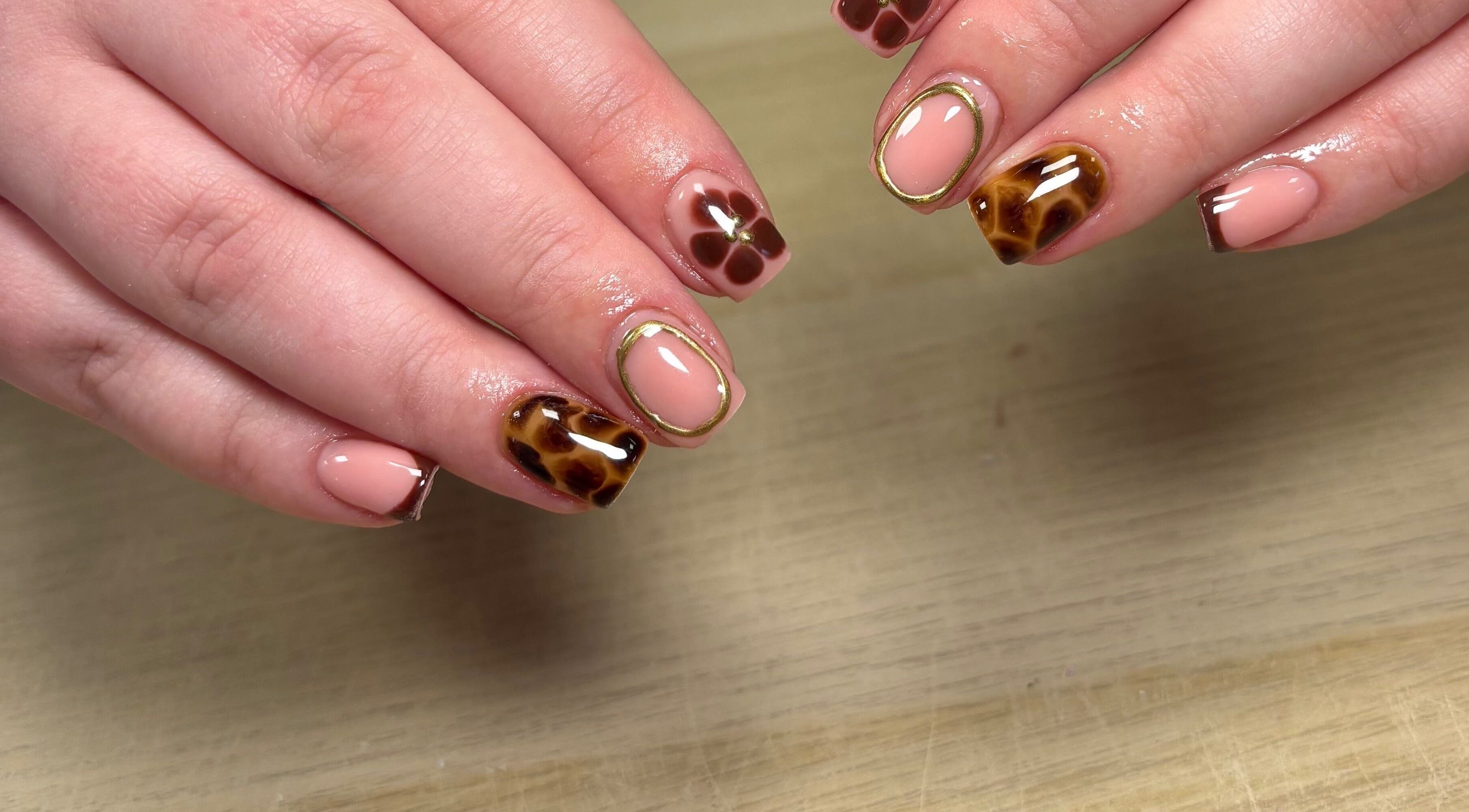Elegant nail art design at Ibrowednlashed, Glasgow, Scotland, GB, featuring neutral tones and intricate patterns.
