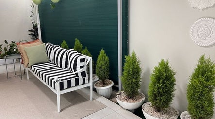 Stylish seating area at Papaya Wellness, Nairobi with striped cushions and potted plants.
