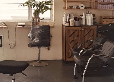 Modern salon setup at Solace Hair, Sandton, Gauteng, ZA with styling chairs and hair care products.