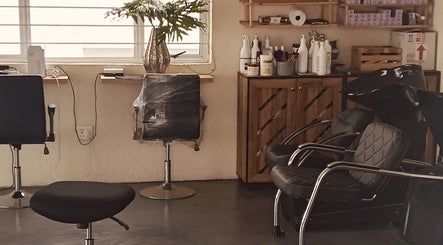 Modern salon setup at Solace Hair, Sandton, Gauteng, ZA with styling chairs and hair care products.