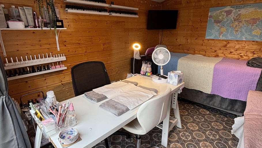 HSbeauty salon in Maidstone, England, GB features a well-equipped, cozy beauty treatment room with wooden decor.