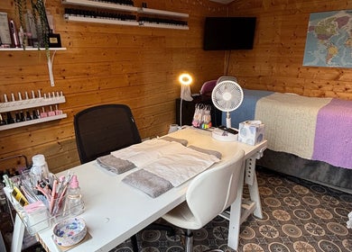 HSbeauty salon in Maidstone, England, GB features a well-equipped, cozy beauty treatment room with wooden decor.