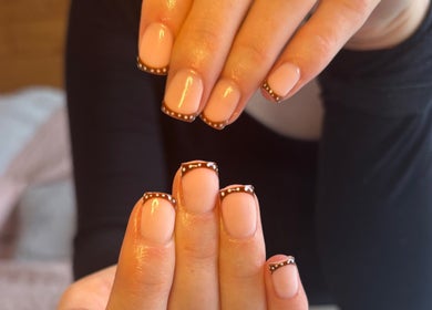Elegant nail art design at HSbeauty in Maidstone, England, GB featuring nude polish with brown tips.