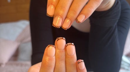 Elegant nail art design at HSbeauty in Maidstone, England, GB featuring nude polish with brown tips.