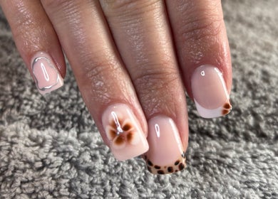 Stylish nail art at HSbeauty, Maidstone, England, GB featuring floral designs on manicured nails.