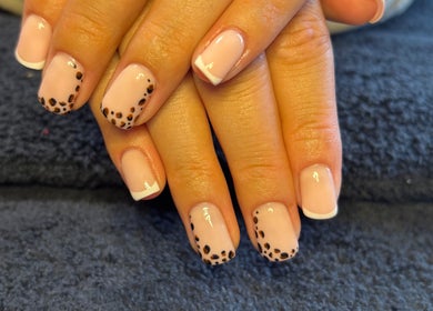 Elegant French manicure with leopard accents at HSbeauty, Maidstone, England, GB.