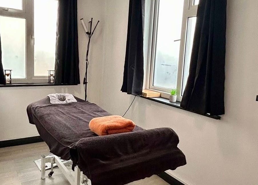 Cozy massage room at Revive Massage Therapy, Guernsey, Vale, GG with a treatment table and soft lighting.
