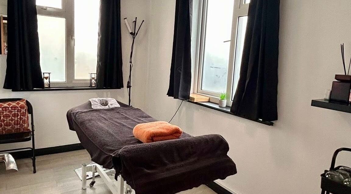 Cozy massage room at Revive Massage Therapy, Guernsey, Vale, GG with a treatment table and soft lighting.