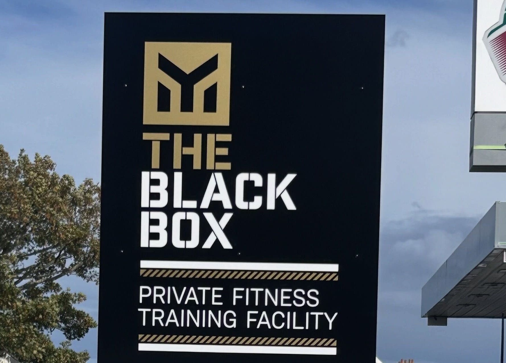 Sign at Revive Massage Therapy, Guernsey, Vale, GG advertising private fitness training facility.