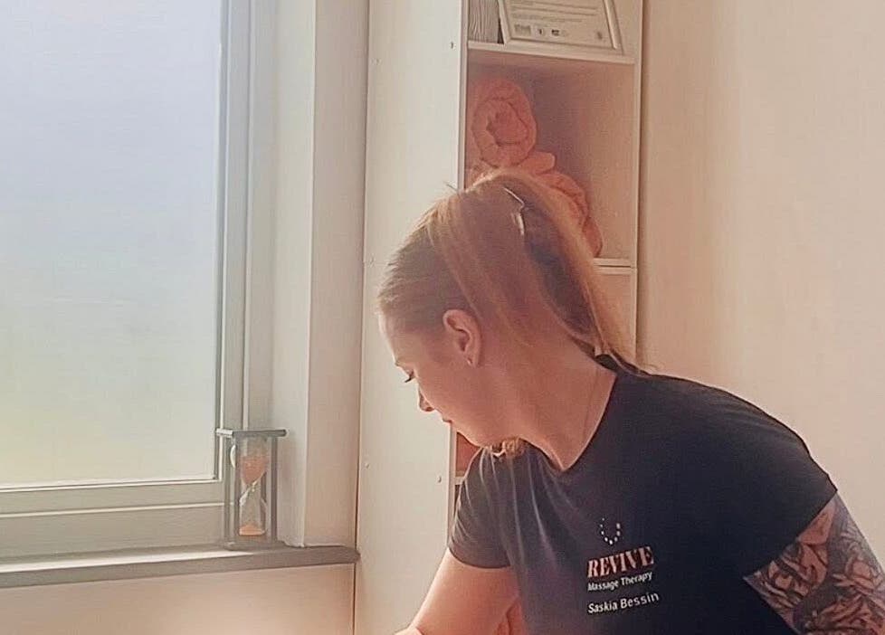 Therapist at Revive Massage Therapy providing a soothing treatment in Guernsey, Vale, GG.
