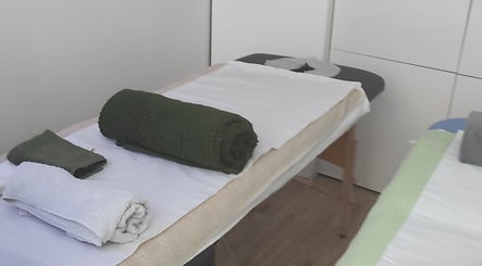 Table de massage chez Janesophrologue à Paris, Île-de-France. Draps et serviettes bien disposés.