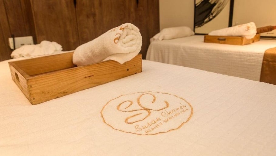 Relaxing massage table setup at SUSAN CHANEL BEAUTY SKINLINE - ALLEN in Ikeja, Lagos, NG with branded linens.